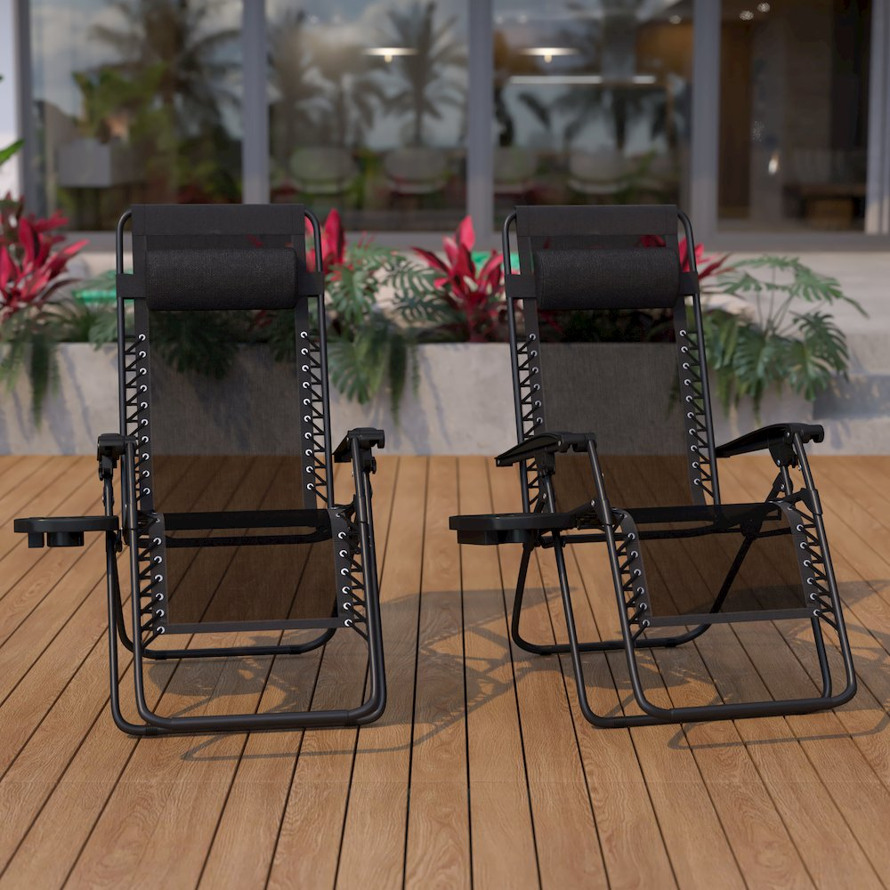 Set of two black Start2Finish adjustable folding mesh zero gravity lounge chairs with pillows and cup holder trays.