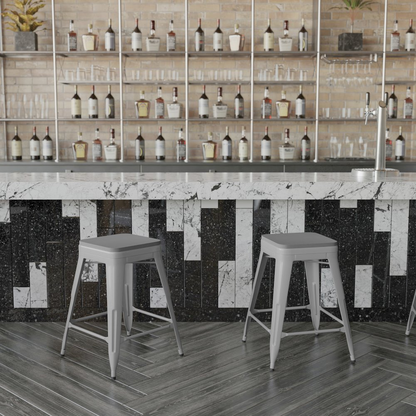 Set of four silver metal indoor counter height stools with backless gray all-weather poly resin seats by Start2Finish.