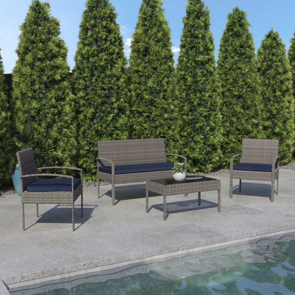 Contemporary outdoor seating set by Start2Finish featuring a sofa, armchair, and glass-top coffee table in a modern outdoor patio setting.