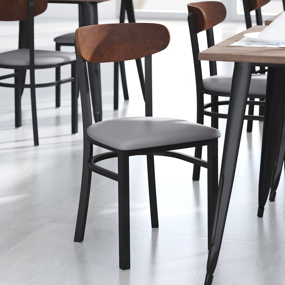 Start2Finish commercial dining chair with vinyl upholstered seat and wood boomerang back for restaurant or cafe seating.