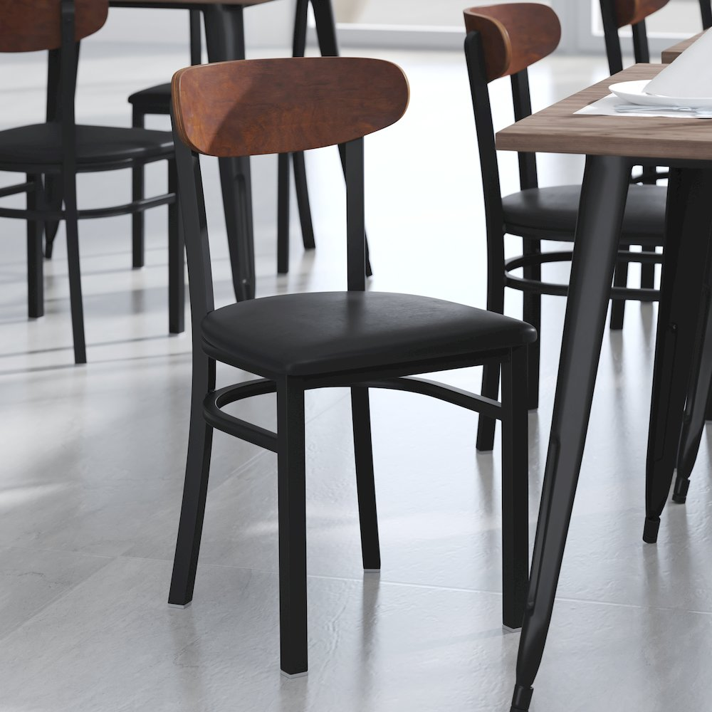 Start2Finish commercial dining chair with vinyl upholstered seat and wood boomerang back, designed for restaurant or cafe use.