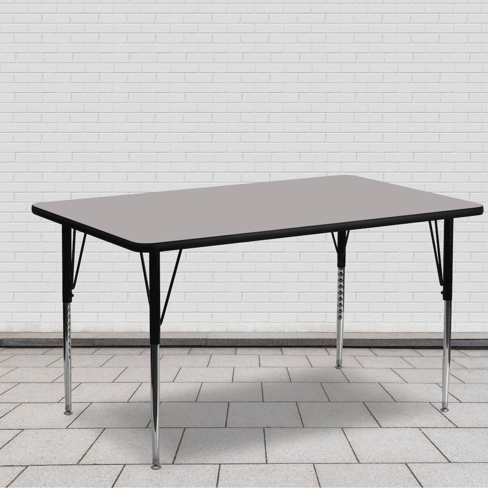 Grey HP activity table by Start2Finish with 24-inch width, 60-inch length, and adjustable standard height legs, shown in a classroom setting.