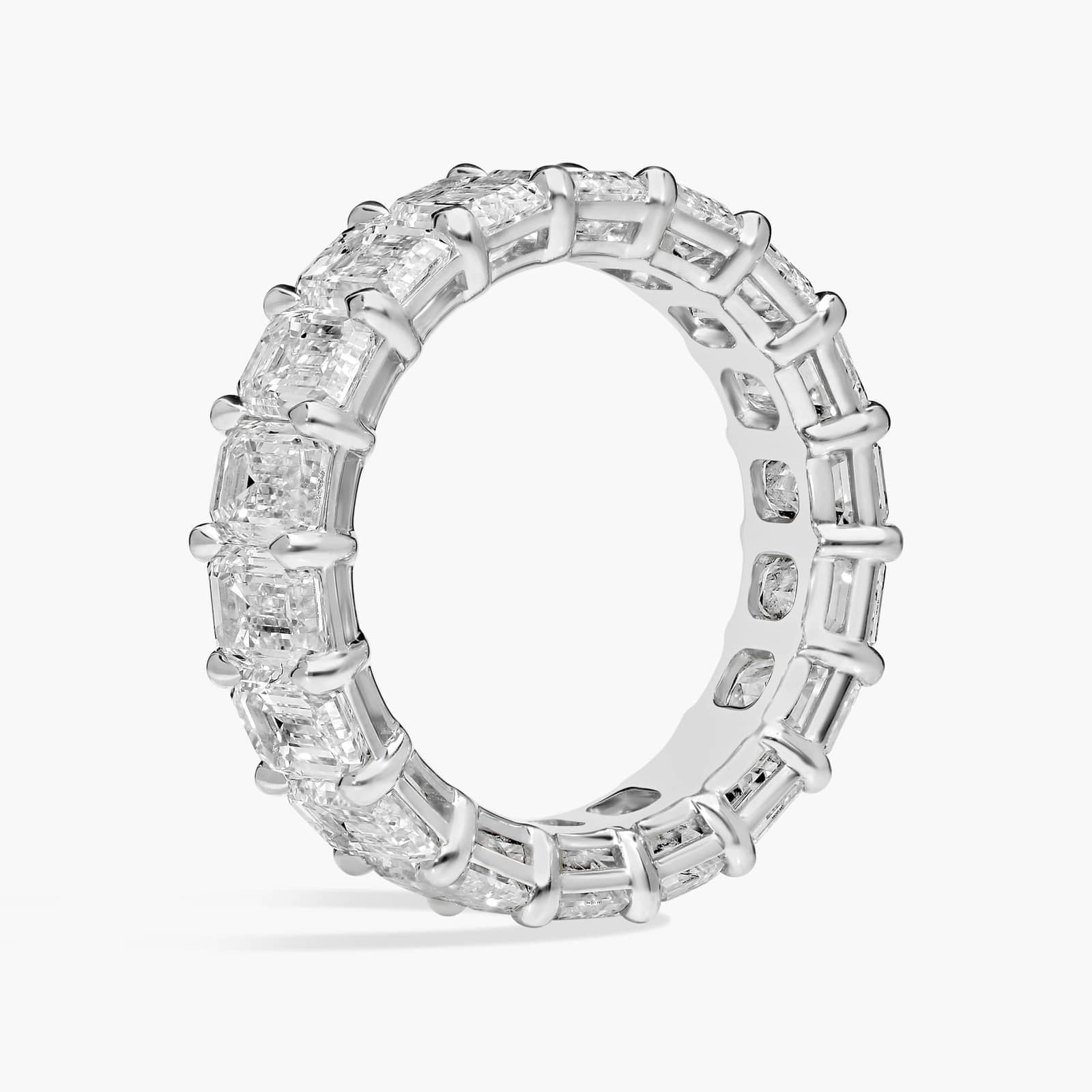 Created Moissanite eternity band ring with 5.00 CTW emerald cut stones in 14k white gold overlay, showcasing sparkling gemstones.