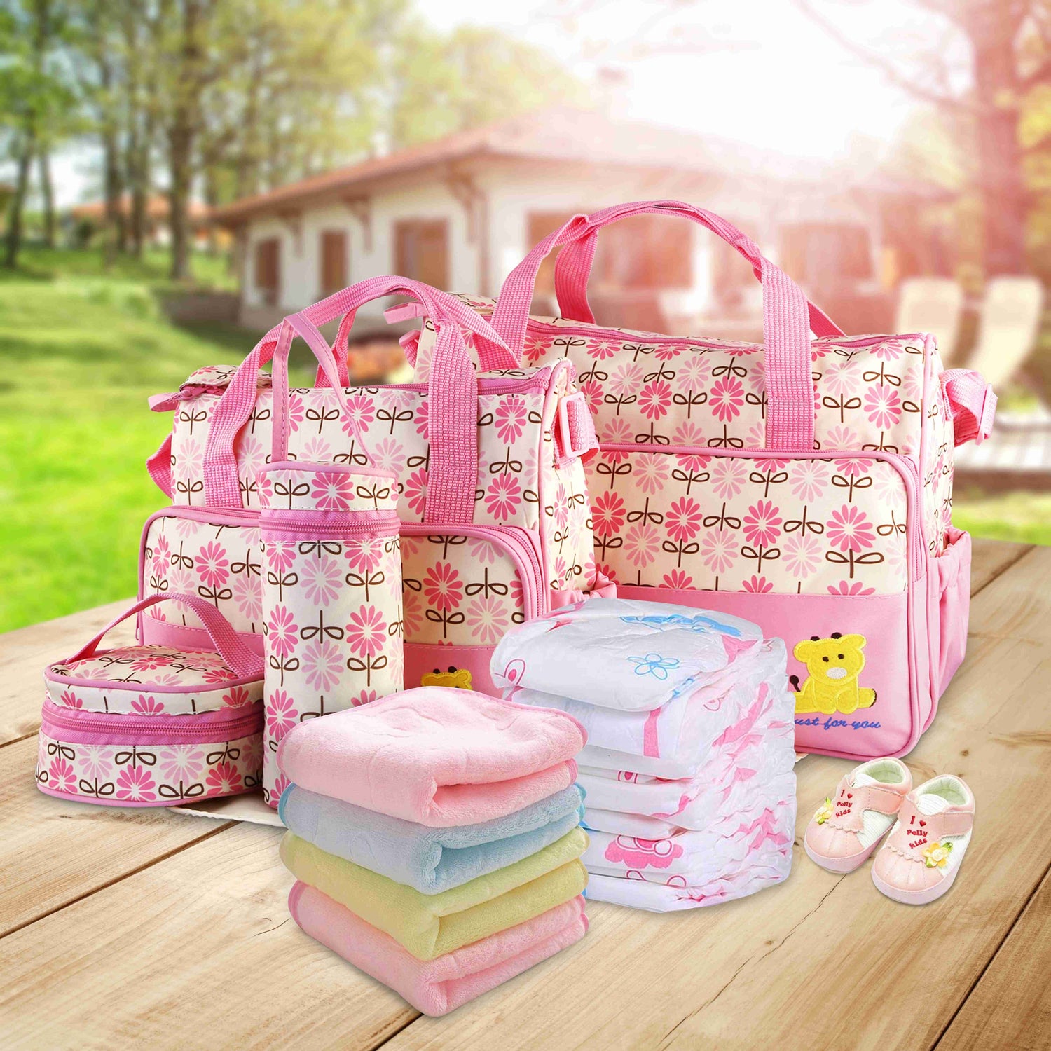 Set of five Pear Daisy baby diaper bags with shoulder straps, ideal for moms to carry baby essentials in stylish home and garden settings.