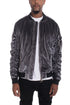 Silver velour cinch sleeve bomber jacket by Lime Milo, featuring a relaxed fit and stylish cinched sleeves, displayed on a hanger.