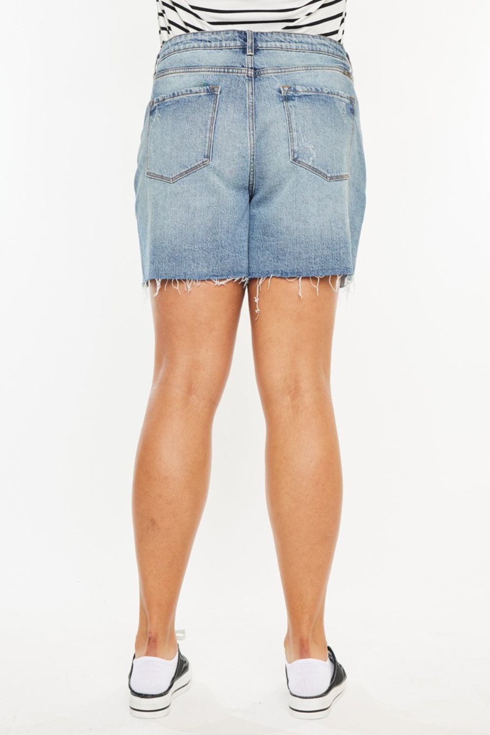 Jade Icarus Kancan high waist denim shorts with raw hem, showcasing their fit and stylish raw edge design.