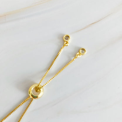 Fuchsia Hercules Mesmerized By The Cross Slide Bracelet featuring a silver-tone cross charm on a sleek chain.