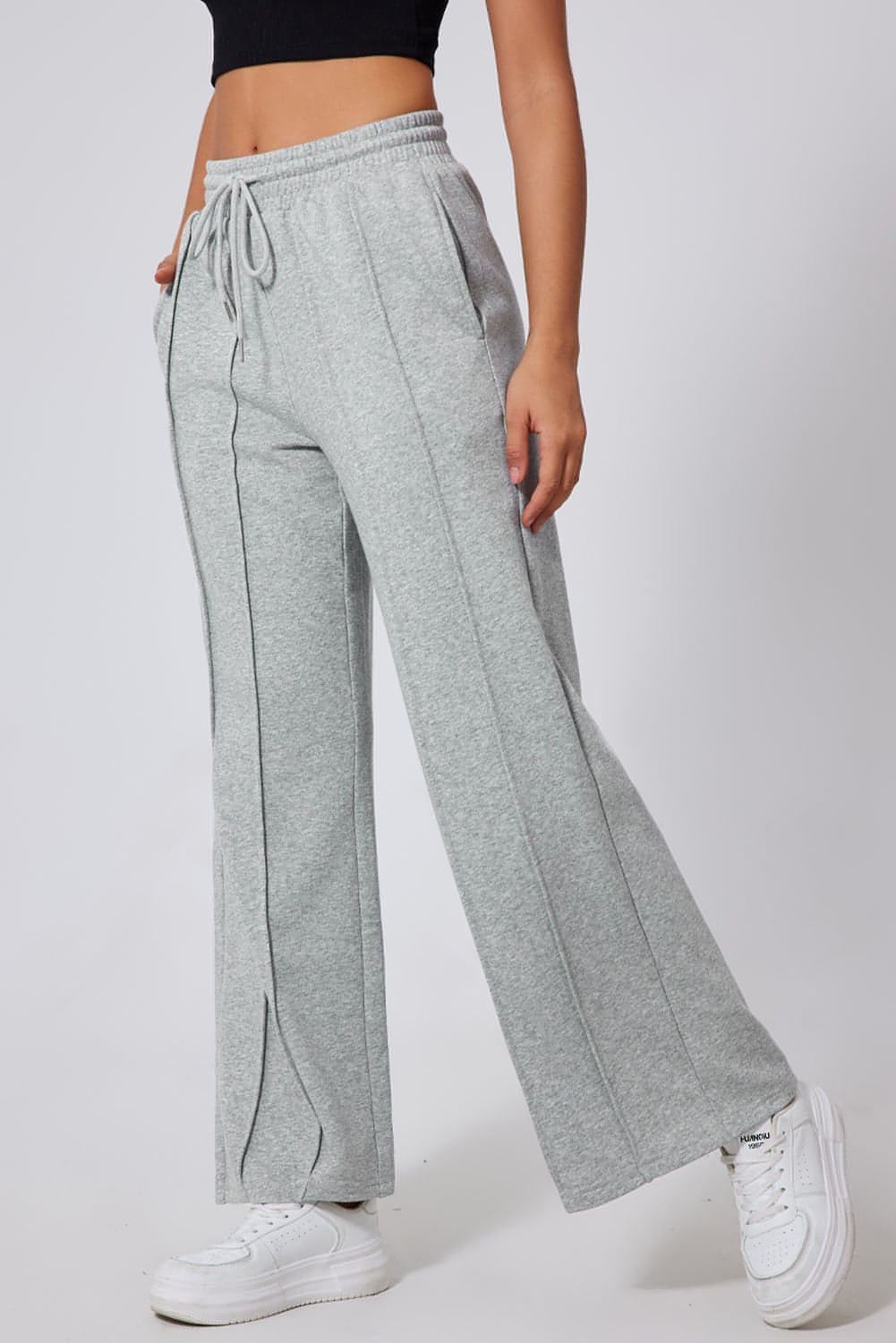 Gray seamed high waist wide-leg sweatpants by Carmine Juneberry with drawstring waist and relaxed fit.