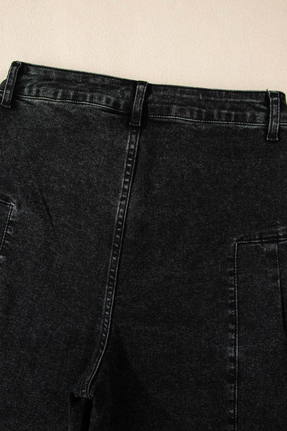 Dark grey pleated wide-leg denim pants by Carmine Juneberry with mineral wash finish, showcased on a model.