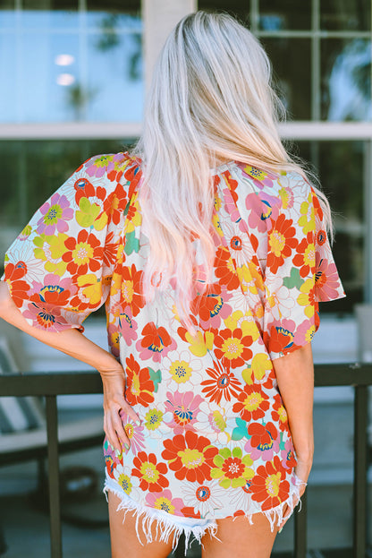 Orange abstract print V-neck blouse with half sleeves from Carmine Juneberry, stylish top for casual or work wear.