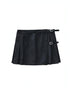 Carmine Juneberry pleated skirt in soft fabric with a flowy silhouette, shown hanging on a hanger against a neutral background.