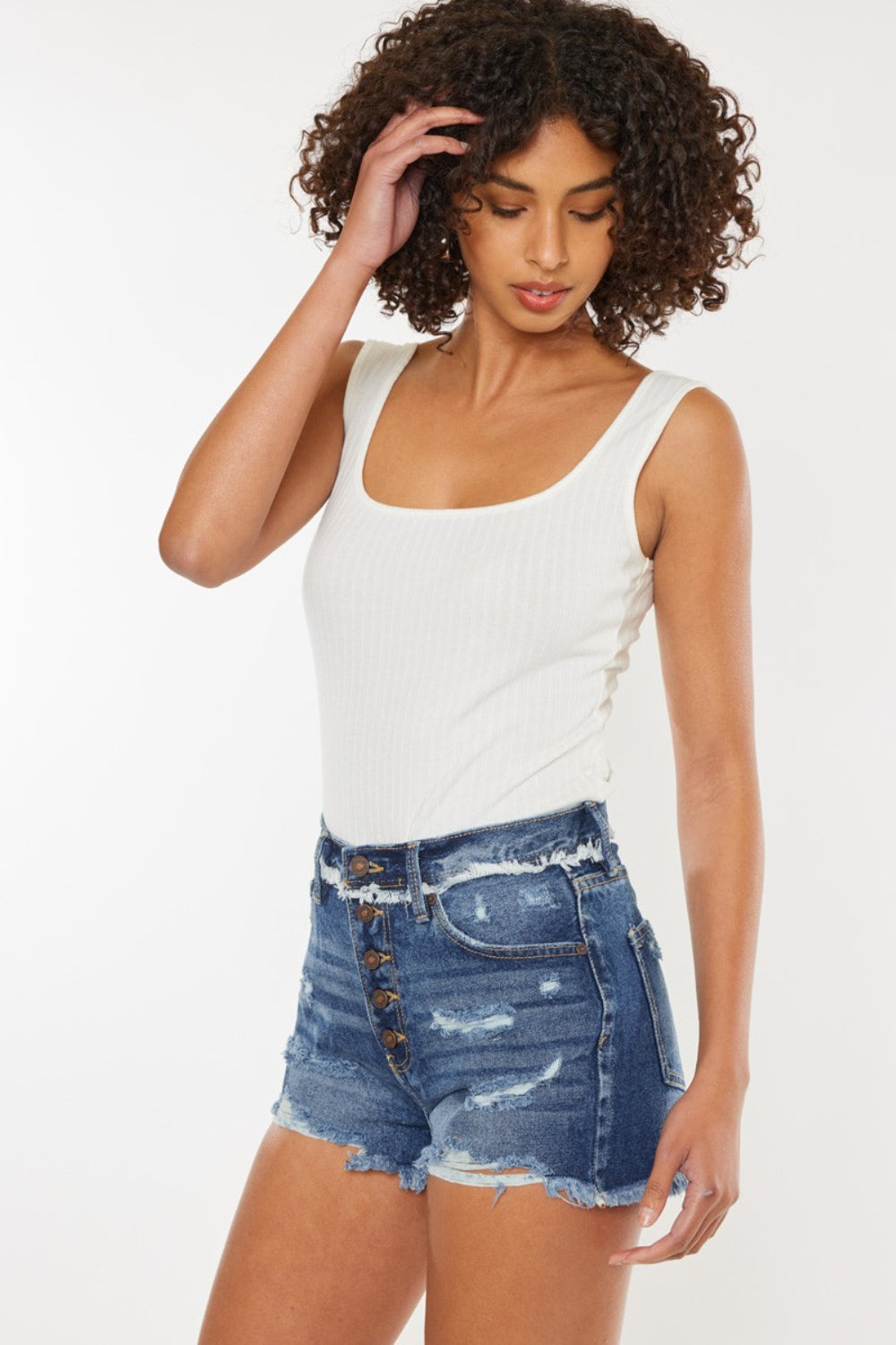 Jade Icarus Kancan distressed button fly denim shorts for women, showing frayed edges and distressed details on light blue denim.