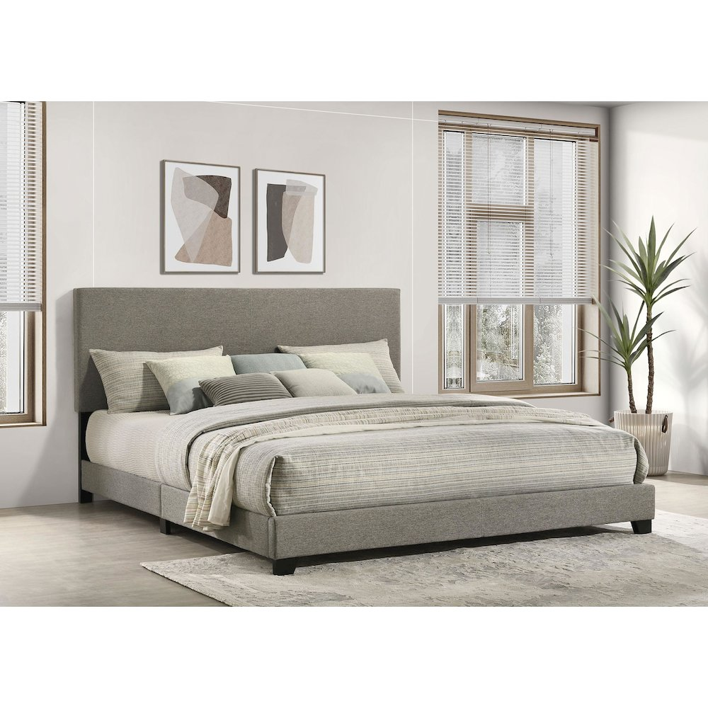 Eastern King panel bed with taupe fabric upholstery and clean-lined design from Start2Finish, shown in a modern bedroom setting.