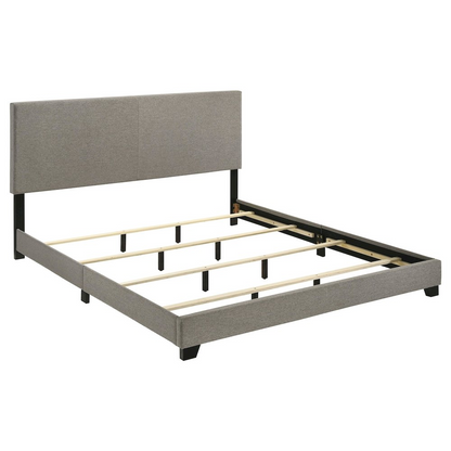 Taupe fabric upholstered California King panel bed with clean lines and a modern design, featuring a sturdy wooden frame and headboard.