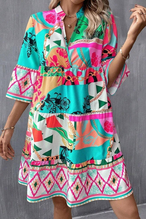 Multicolour abstract printed mini dress with half sleeves and notched neck by Carmine Juneberry, shown on a model.