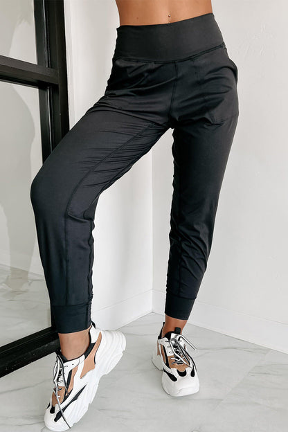 Black high waist joggers with exposed seams and pockets, from Carmine Juneberry. Comfortable, stylish gift-ready casual pants.