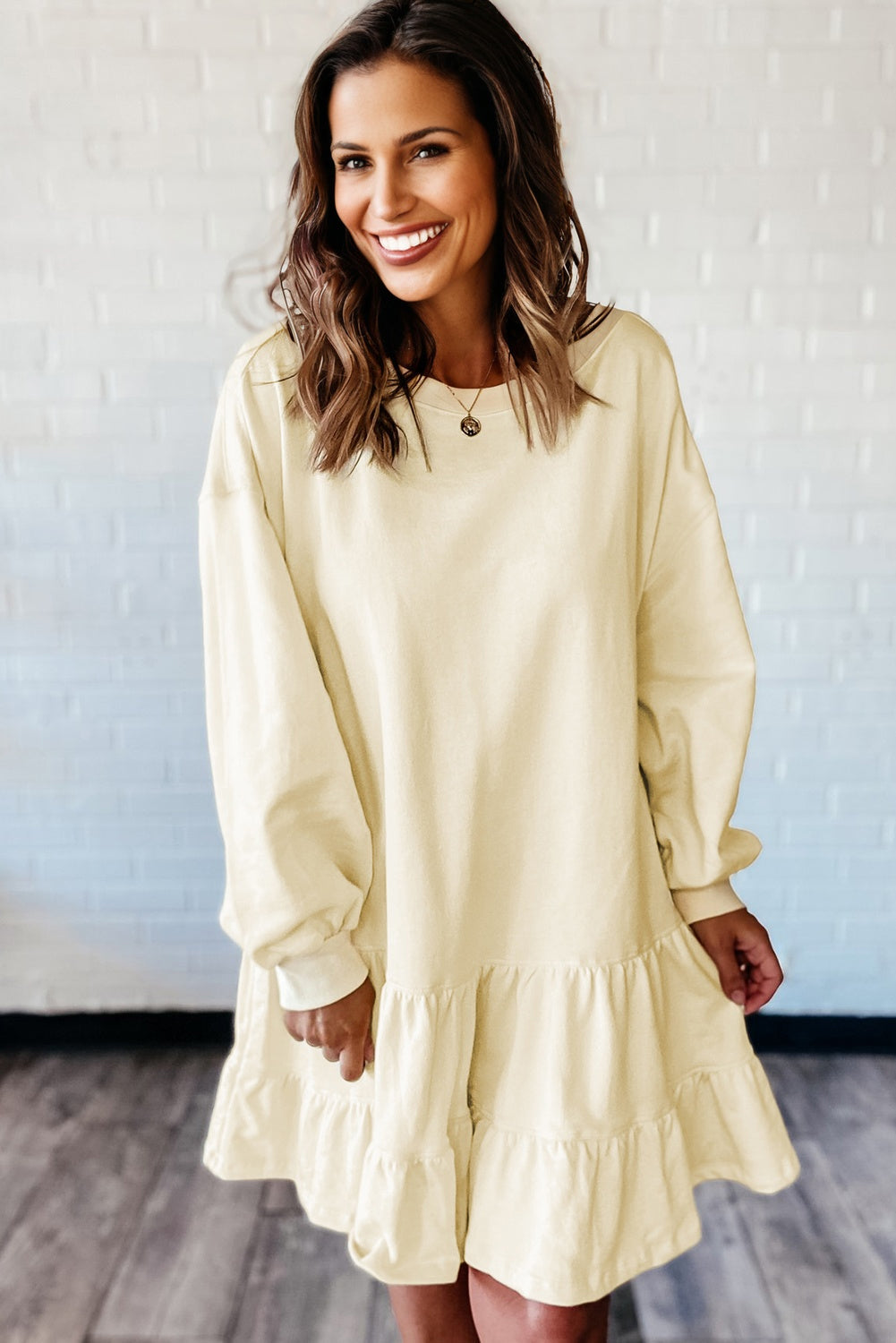 Solid tiered ruffle hem long sleeve dress by Byzantium Bay, featuring layered fabric and elegant design.