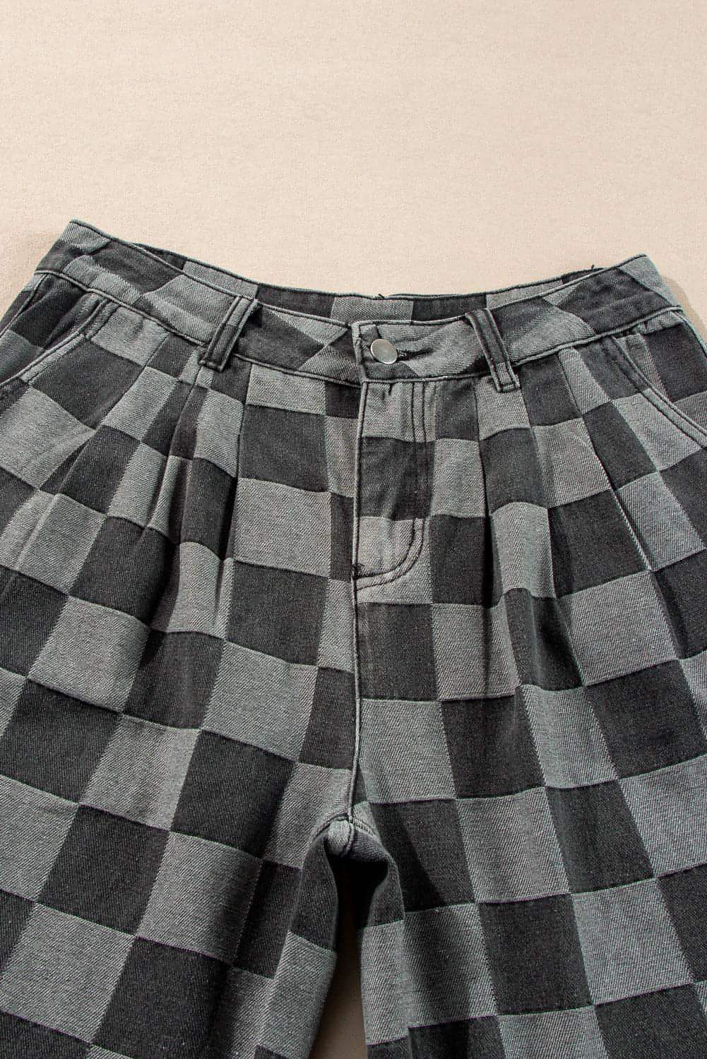 Dark grey checkered denim wide-leg pants by Carmine Juneberry, showing the relaxed fit and stylish pattern.