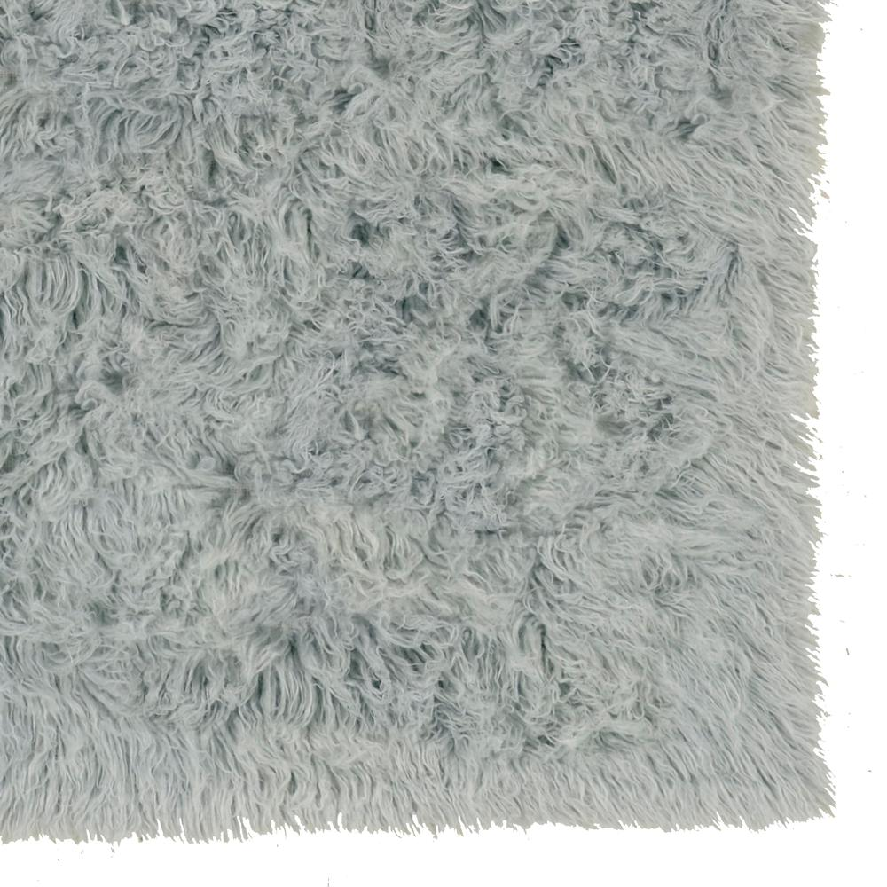 Light grey Flokati rug by Start2Finish, 5x8 feet, plush 1400-gram wool area rug with soft, textured surface.