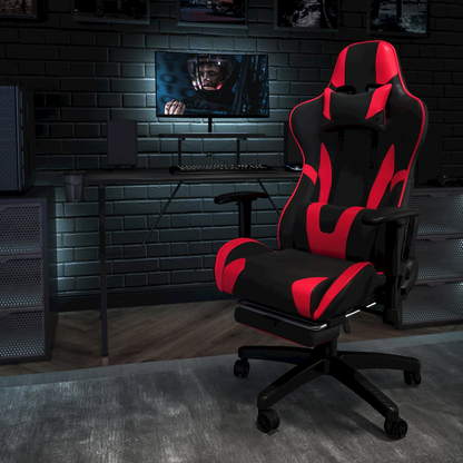 Black gaming desk with a matching red and black gaming chair and footrest, designed for ergonomic gaming setup.