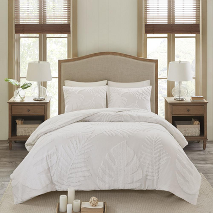 Three-piece tufted cotton chenille Palm Comforter bedding set with matching pillow shams and decorative accents.