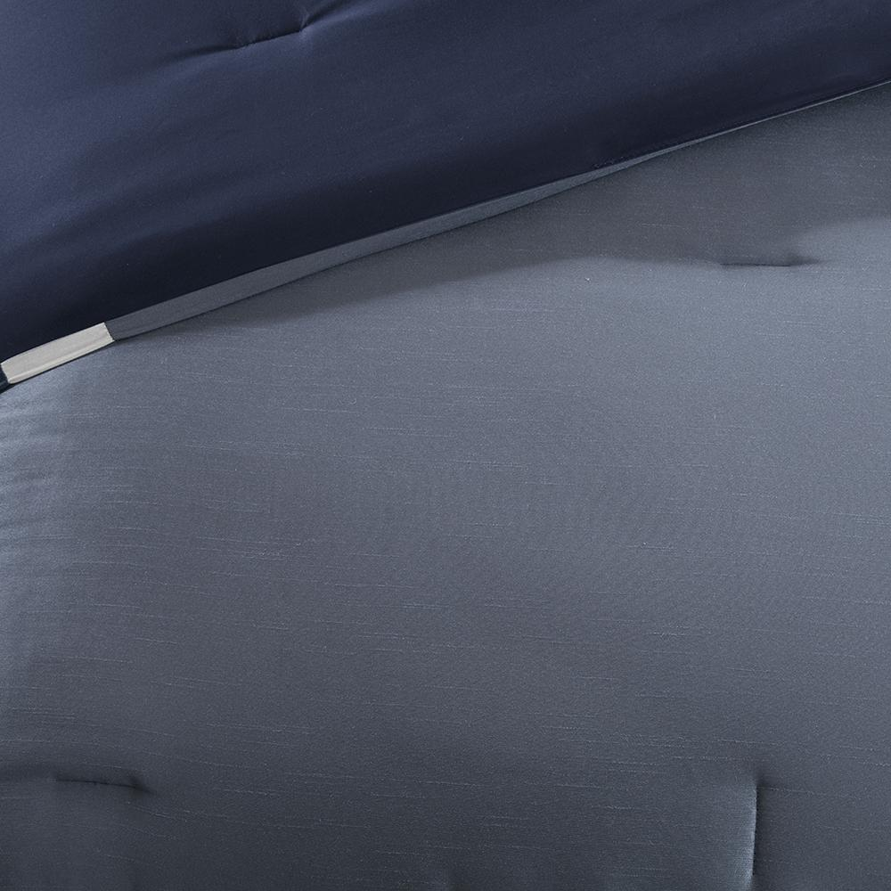 Start2Finish Genevieve 7-piece navy bedding comforter set with decorative pillows and matching sheets on a bed.