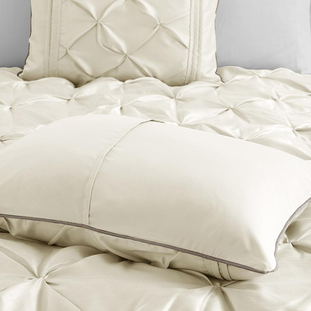 Start2Finish Laurel 7-piece tufted comforter set in ivory with matching pillow shams displayed on a bed.