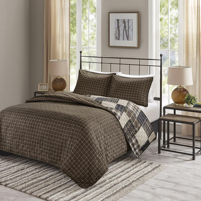 Timber 3-piece reversible printed quilt set from Start2Finish in black and brown bedding with woodgrain pattern.