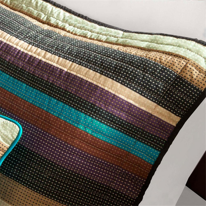 Start2Finish Yosemite reversible quilt set with colorful bedding and matching throw pillows on a neatly made bed.