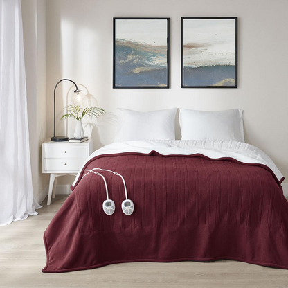 Start2Finish heated blanket spread out on a bed, showing its soft fabric and electric control panel for warmth adjustments.
