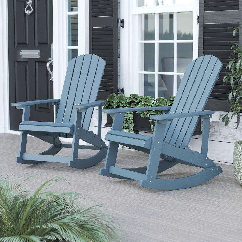 Two sea foam Adirondack rocking chairs by Start2Finish, featuring wide armrests and curved backrests, set on a grassy outdoor area.