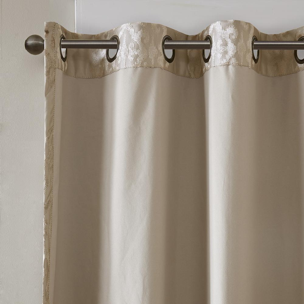 Pair of black knitted jacquard damask blackout grommet top curtain panels for home decor, featuring intricate woven patterns and metal grommets.