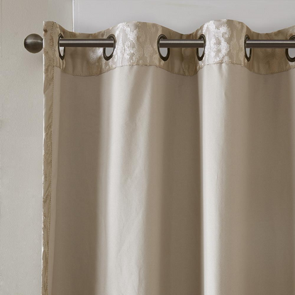 Pair of black knitted jacquard damask blackout grommet top curtain panels for home decor, featuring intricate woven patterns and metal grommets.