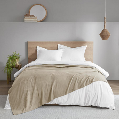 Lightweight tan cotton gauze blanket by Start2Finish, soft and breathable 100% cotton fabric, draped for display.