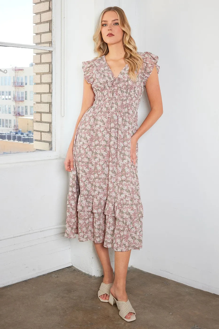 Automotive-themed image with a floral print ruffle cap sleeve v-neck midi dress by Jade Icarus, featuring vibrant patterns and elegant design.