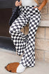 Black checkerboard high rise casual flared pants by Carmine Juneberry, showing the stylish pattern and wide-leg silhouette.
