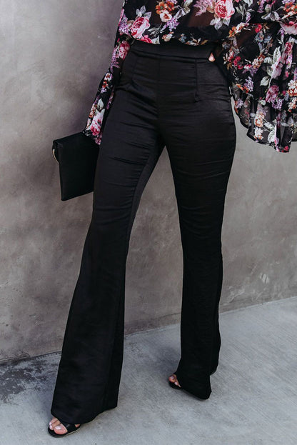 Black satin flare tailored pants by Harlequin Daisy, showcasing sleek, fitted design with flared legs and smooth satin fabric.