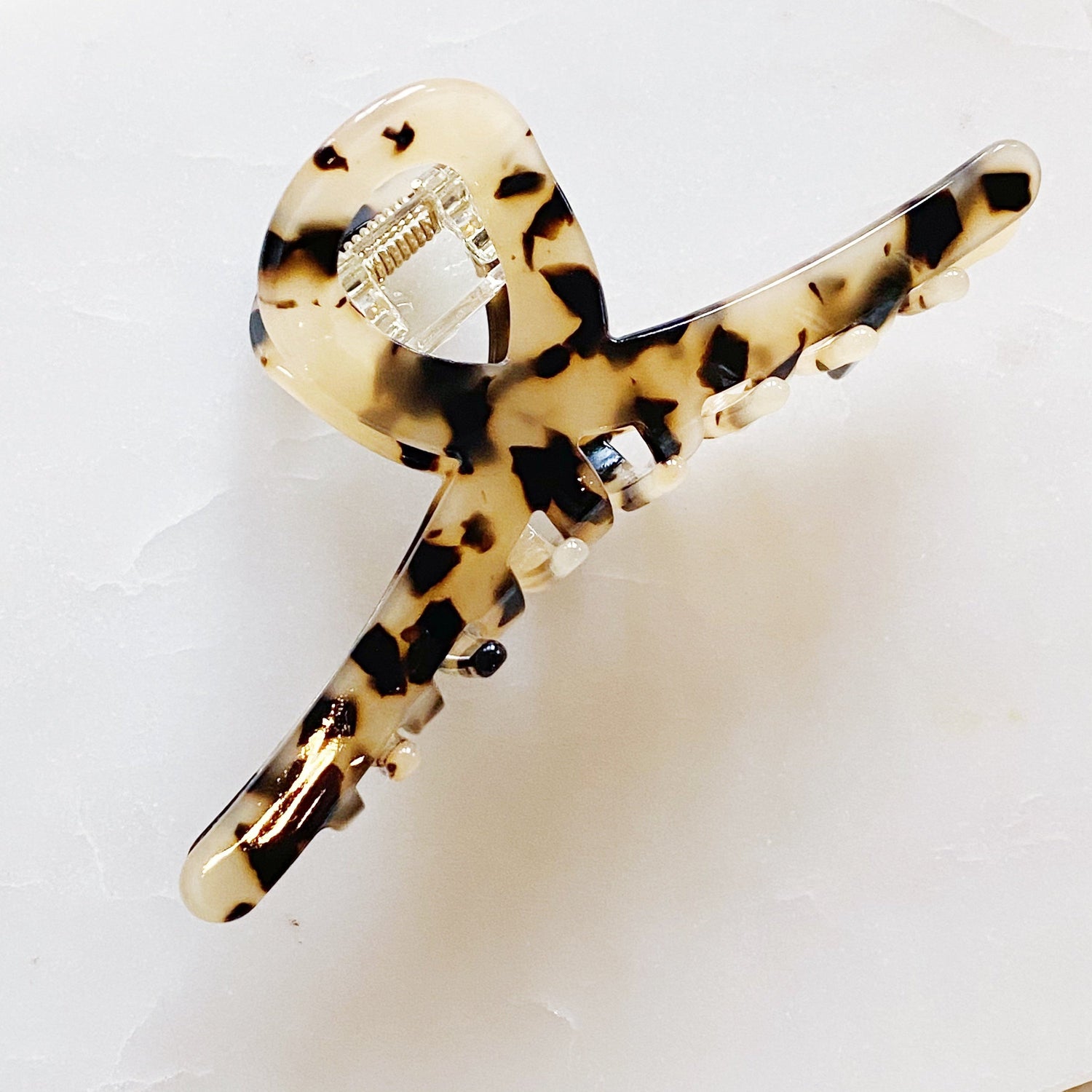 Fuchsia Hercules Barely There Hair Claw jewelry accessory with sleek design, shown holding hair in a stylish manner.