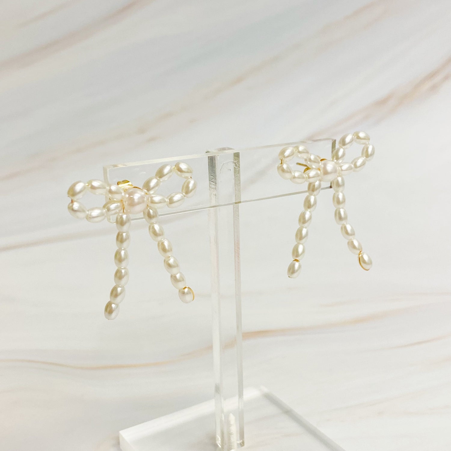 Fuchsia Hercules Pearl Bow Ballerina Earrings featuring white pearls and delicate bow design, jewelry and watch accessory.