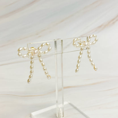 Fuchsia Hercules Pearl Bow Ballerina Earrings featuring white pearls and delicate bow design, jewelry and watch accessory.