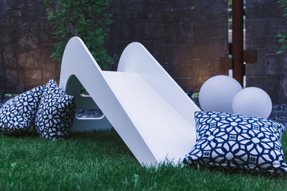 White wooden indoor slide for kids by Rose Metis, featuring a sturdy, smooth surface suitable for children and babies.