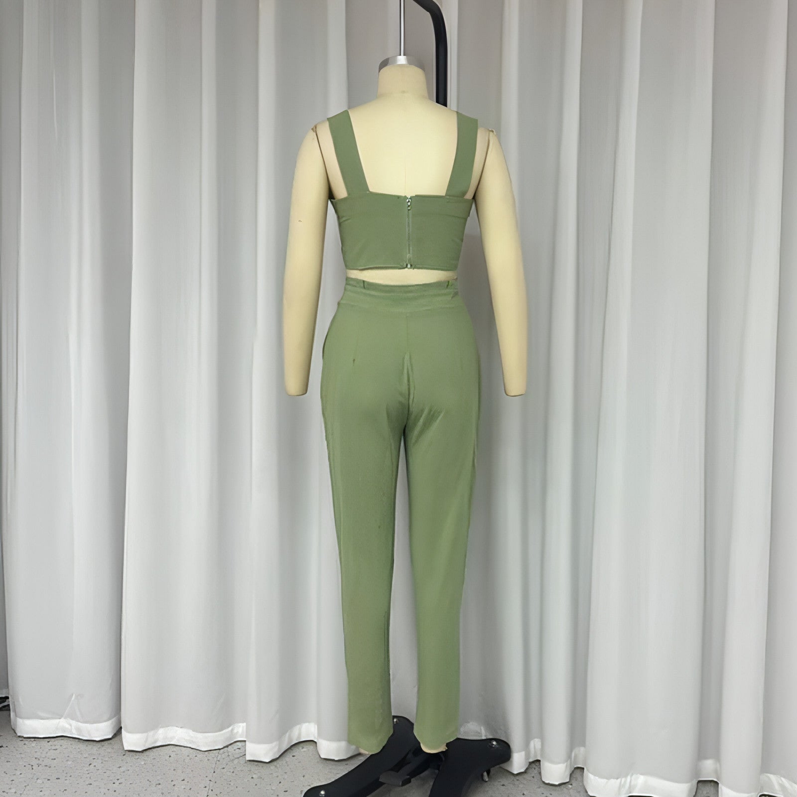 Carmine Juneberry matching set with a short crop-top spaghetti strap top and high-waist trousers, stylish two-piece outfit.