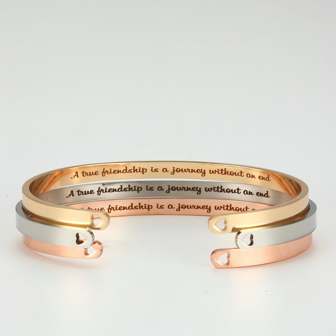 Personalized couple bracelet by Carmine Juneberry featuring sleek steel design for him and her, with engraved details visible.