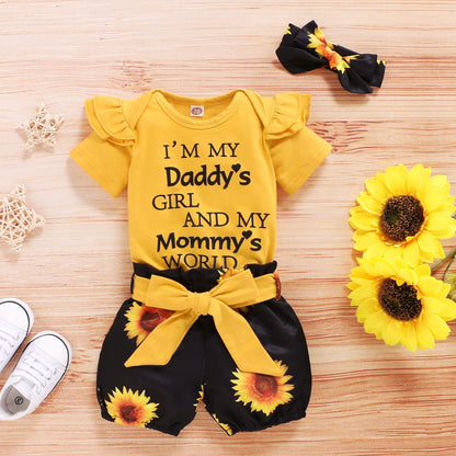 Baby girl wearing SunnyBloom™ sunflower-themed 3-piece outfit by Carmine Juneberry, featuring bright yellow sunflower prints and soft fabric.