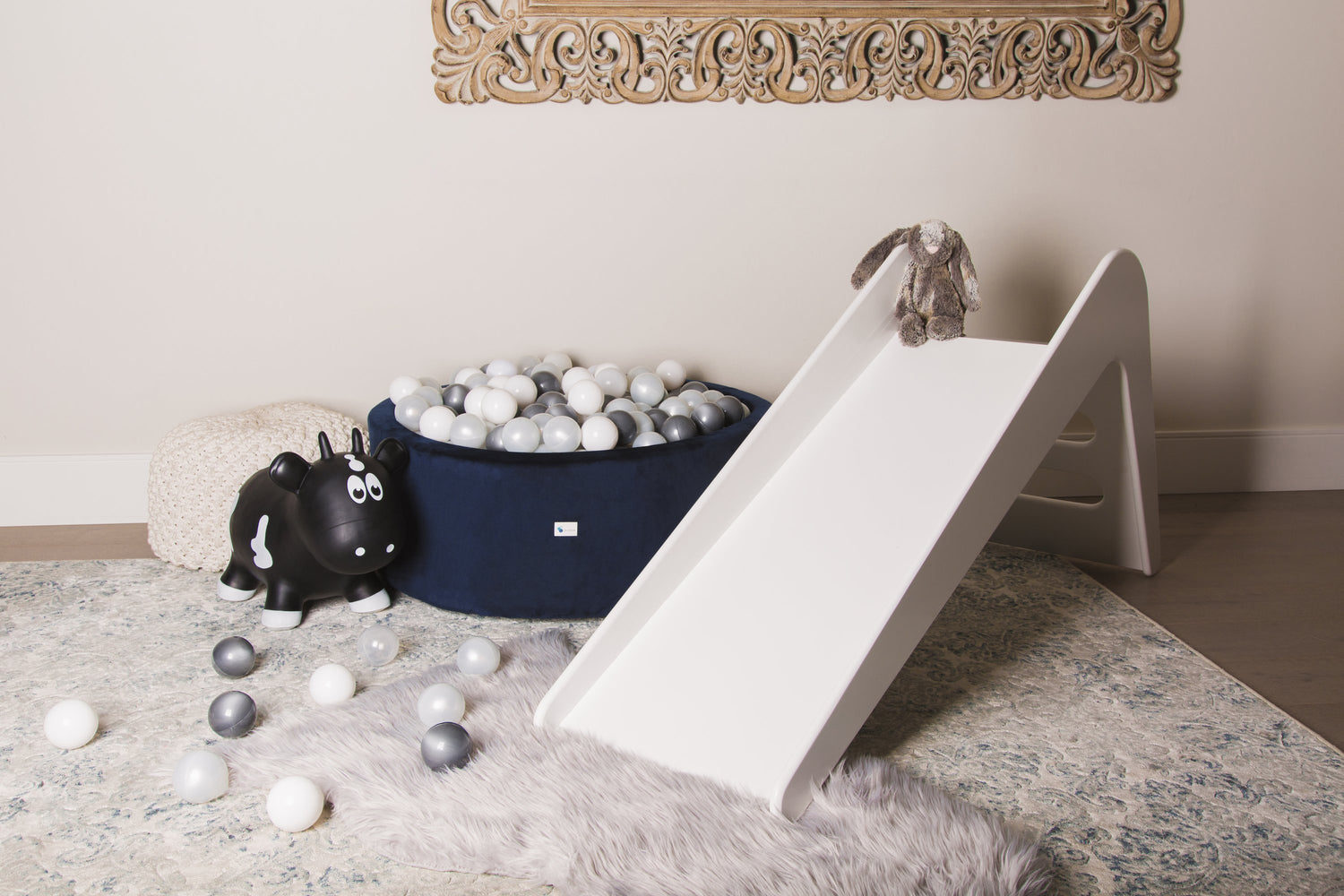 White wooden indoor slide for kids and babies by Rose Metis, showcasing a smooth, sturdy slide perfect for indoor play spaces.