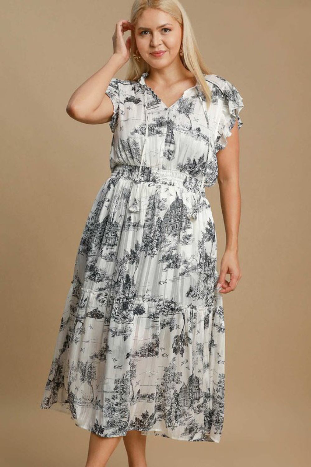 Plus size Umgee landscape print midi dress by Jade Icarus featuring a two-tone design, displayed on a hanger.