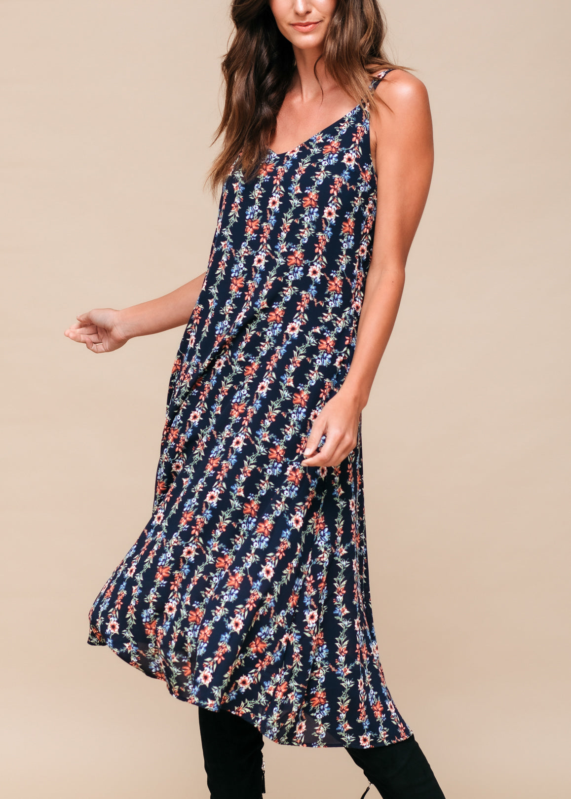 Black floral V-neck sleeveless maxi dress by Lemon Hera with a flowing silhouette and vibrant floral print.