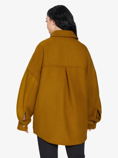 Rose Eleusis oversized patch pocket shacket featuring a relaxed fit, button-up front, and large front patch pockets.