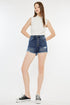 Jade Icarus Kancan raw hem button fly denim shorts with distressed detailing and casual style, shown on a model.