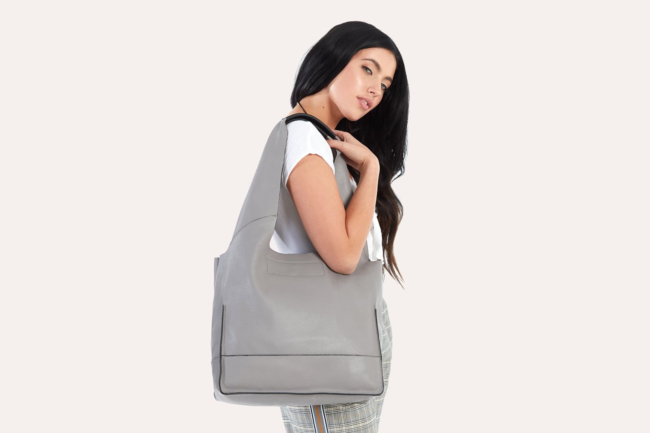 Pink Lucy modern tote bag with sleek design, featuring sturdy handles and spacious interior for accessories and daily essentials.